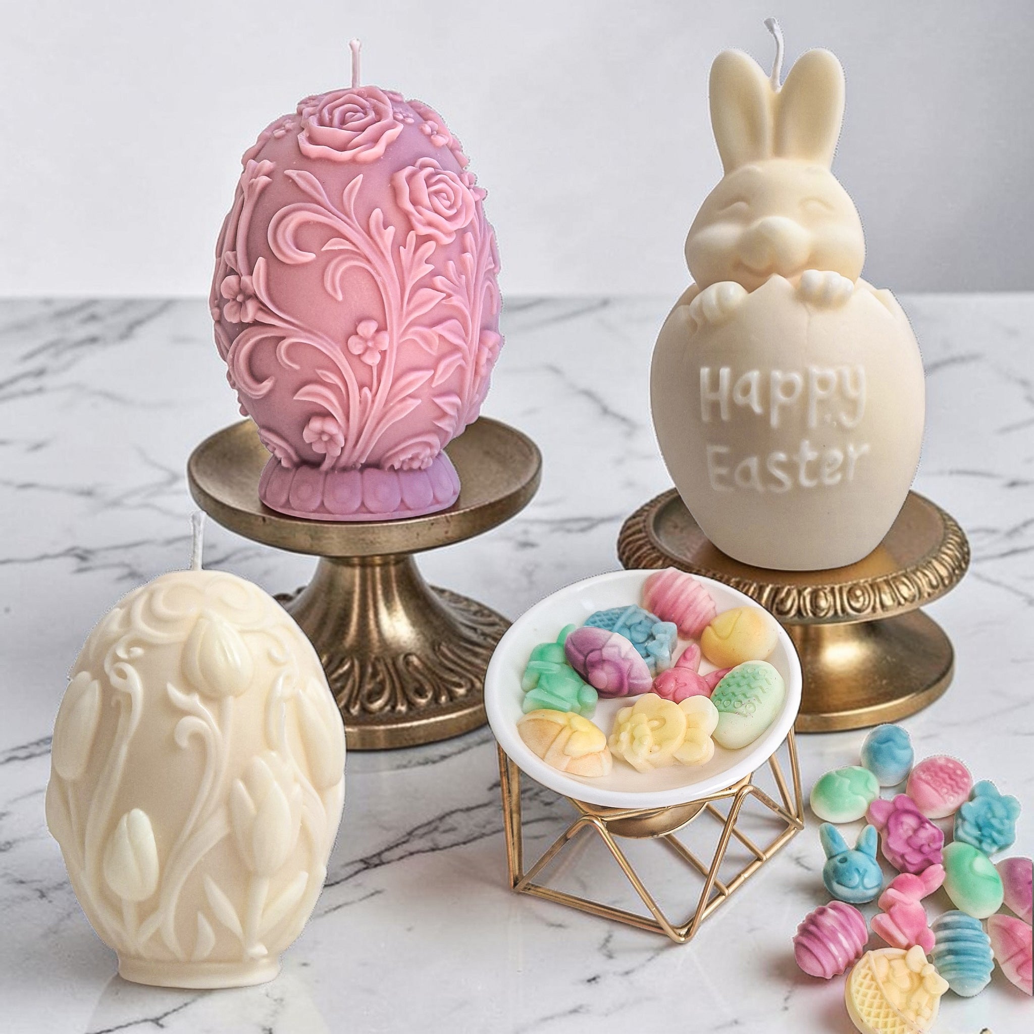 Decorative Easter soy wax candles and wax melts on a marble surface