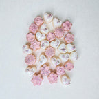 Assorted heart, flower and star-shaped soy wax melts with glitter dust on a light background.